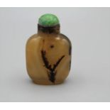 Snuff Bottle. Chalcedony of rounded rectangular form on a broad raised footrim, lightly incised