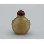Snuff Bottle. Chalcedony of compressed ovoid shape, raised on a neatly formed oval footrim, with tao