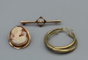 A selection of yellow metal jewellery, comprising a cameo brooch/pendant, a pair of 9ct creole