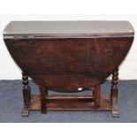 A late 18th century oak gateleg table of pegged construction, the rectangular top and twin demi-lune