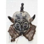 A 20th century carved wood African Tribal mask, with horns, closed eyes and woven cloth collar,