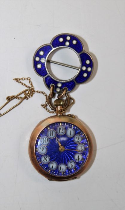 A yellow metal ladies watch, with an attractive blue guilloche dial with Roman numerals in white