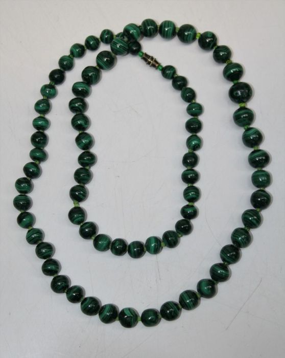 Early 20th century strand of graduated malachite beads, interspersed with glass bead spacers,