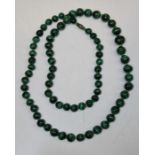 Early 20th century strand of graduated malachite beads, interspersed with glass bead spacers,