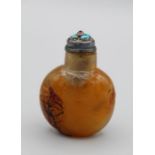 Snuff Bottle. Chalcedony of compressed ovoid form resting on an oval base, carved overall in light