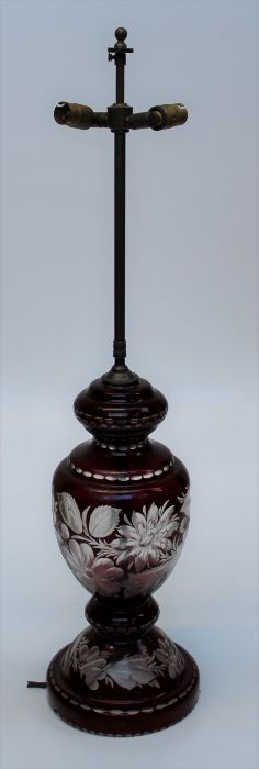 An early 20th century Bohemian ruby flash glass table lamp of generous size with twin brass light