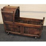 A 19th century oak rocking cradle, of pegged and panel construction. 110cm