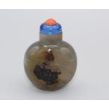 Snuff Bottle. Chalcedony of compressed ovoid shape on a small oval base, the darker layer in the