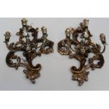 A pair of 20th century Rococo form carved wood, metal and parcel gilt three light wall sconces, 60cm