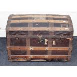An Edwardian wood banded dome top cabin trunk with twin side handles and vacant interior, 76cm wide