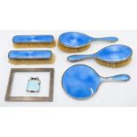 An early 20th century silver and blue guilloche enamel brush set comprising two hair brushes two
