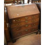 George III oak bureau with four single drawers, below a drop down writing top, on bracket feet