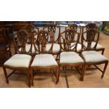 A set of eight reproduction dining chairs, including two carvers, each with decorative splat and