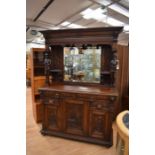 A large solid oak Victorian mirror-back Sideboard with two carved supports of men playing bagpipes