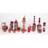 A collection of late 19th and early 20th Century cranberry glass including silver topped decanter,