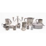 A collection of late 19th and 20th Century pewter items including measures, candlesticks, plates,