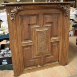 A large oak over-mantel panel with carved corner and central detail along with its mantel shelf,