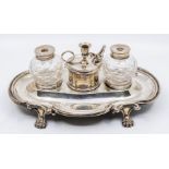 A 19th Century Old Sheffield plate shaped oval inkstand, ornate curving border on four paw feet,