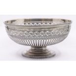 A George V silver large circular reticulated bowl, geometric decoration, on raised foot,