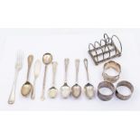 A collection of silver to include: A silver toast rack on ball feet hallmarked for Sheffield 1918 by