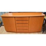 A 1970s bow-fronted teak Sideboard by Skovby with five central drawers flanked by two cupboard