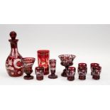 A Bohemian red flash glass decanter and six liqueur glasses, together with four other red flash