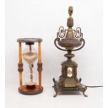 Brass and marble lamp on a stand, along with an egg timer.