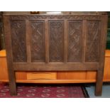 A large carved headboard - Rupert Griffiths, 20th century. Size approx 177cm high, 153cm wide.