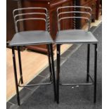 A pair of modern chrome and black kitchen stools