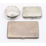 Two George V silver cigarette cases, both hallmarked Birmingham, 1917 and a George V silver circular