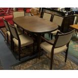 A rosewood dining table with extra extension leaf and six chairs