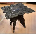 Early 20th Century carved Indian occasional folding table, dark wood, with grape vine detailing