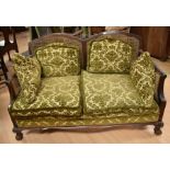 An early 20th Century two-seater mahogany bergere sofa chair