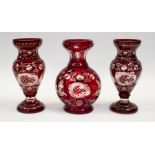 A pair of Bohemian red flash glass vases, together with a similar design larger vase all in good