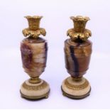 A fine pair of Regency ormolu mounted Blue John candlesticks, of baluster form raised upon stepped