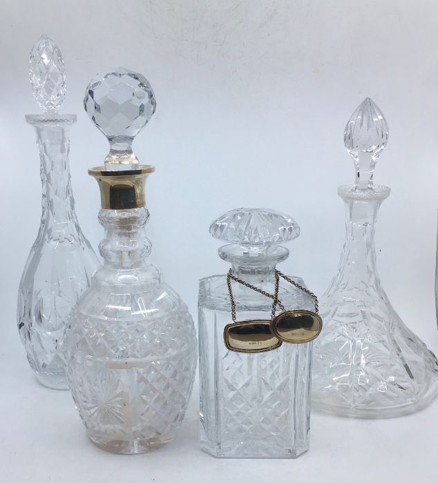 Four various 20th century glass decanters, to include a silver mounted hobnail cut glass decanter,