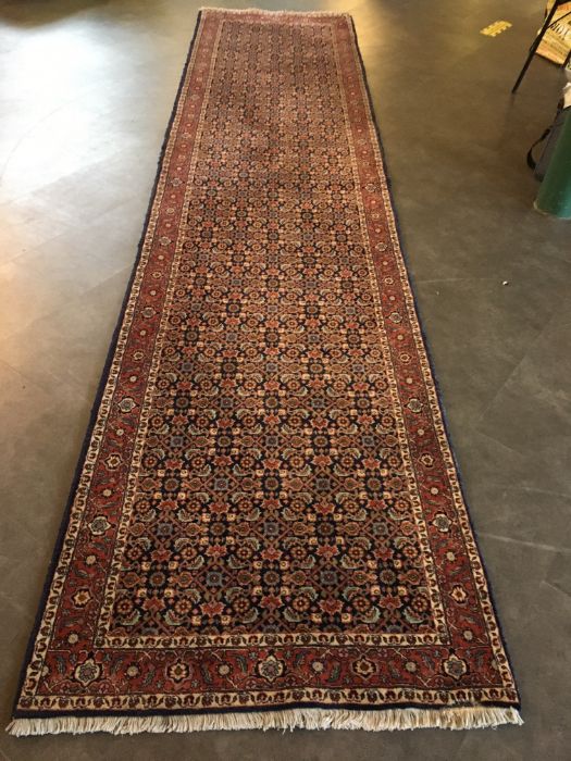 A large Persian runner. 390 x 92cm