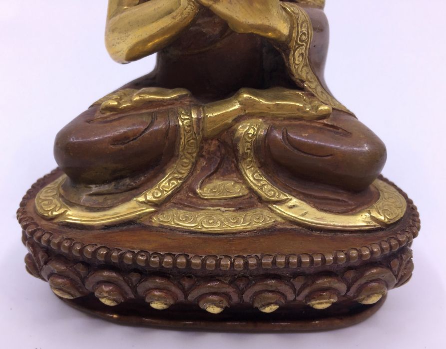 A 20th century Sino-Tibetan gilt and polychrome painted bronze figure of seated Buddha with hands in - Image 3 of 5