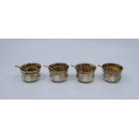 A set of four Victorian silver circular salts with silver Onslow pattern salt spoons, all by