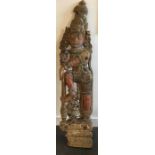 A large Indian carved wooden architectural block depicting a deity, late 19th/early 20th century,