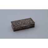 A 19th century white metal rectangular snuff box, the hinged lid repousse and chased scene of