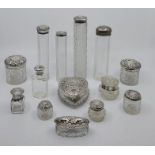 Fourteen various silver mounted glass vanity jars and bottles, various dates and makers. (