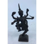 A late 19th century bronze figure of a standing six armed deity, height 10cm.