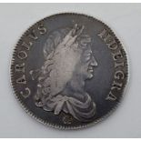 A Charles II 1662 silver crown, obv. first bust, rose below, edge not dated.