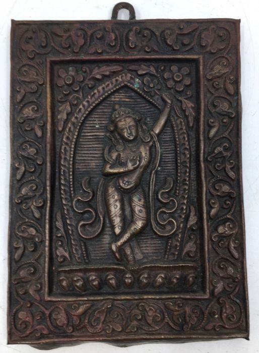 A 20th century Indian cupro-bronze plaquette, with deity to centre, 13.5cm x 9.9cm.