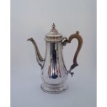 A large silver coffee pot, by C J Vander Ltd, London 1968, height 28cm. (gross weight 972.6g/31.