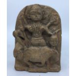 An Indian carved sandstone slab depicting a four armed deity, height 16cm.