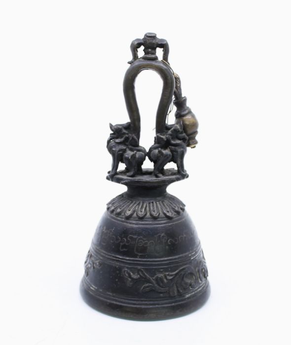 A late Ming style bronze vessel in the form of a Bell, with loop cast handle and Dog of Fo