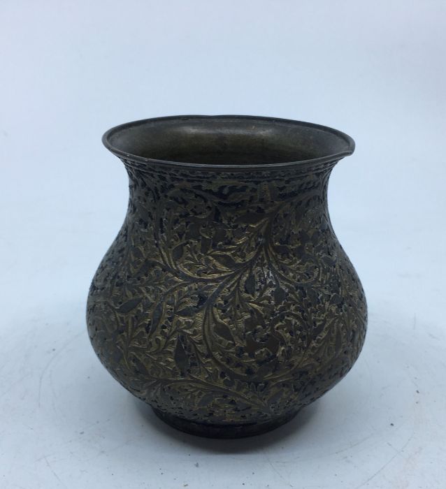 A 20th century Indian white metal vase, the side engraved foliate decoration, height 8.8cm.