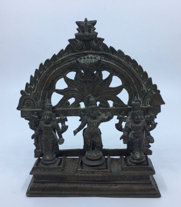 A 19th century Indian bronze group of three deities, to associated base, height 17cm.